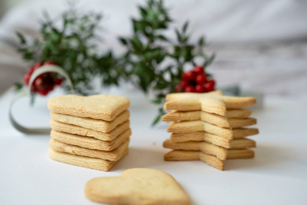 Heart and star-shaped cookies on a white table, perfect for festive holiday treats.
